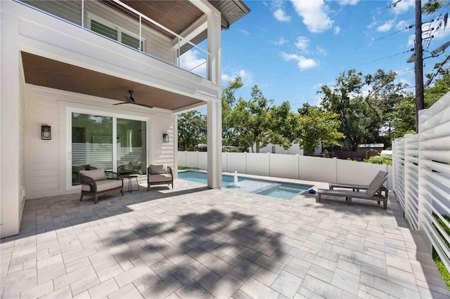 2596 Floyd St, Sarasota, FL 34239 - view of patio / terrace featuring ceiling fan, a balcony, a fenced backyard, outdoor lounge area, and a pool with connected hot tub