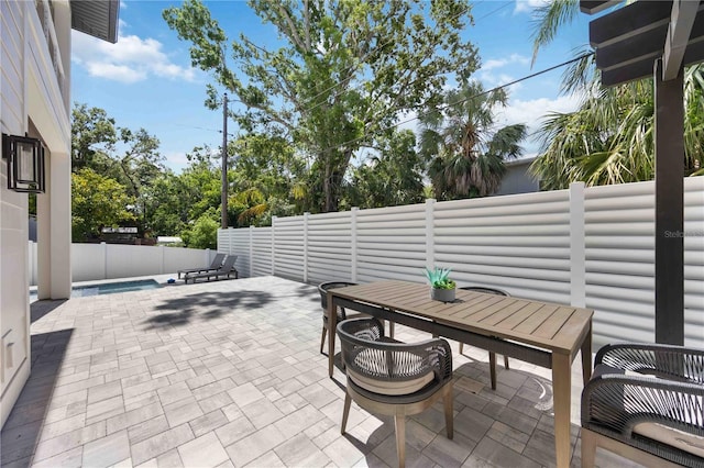 2596 Floyd St, Sarasota, FL 34239 - view of patio with a fenced backyard and outdoor dining area