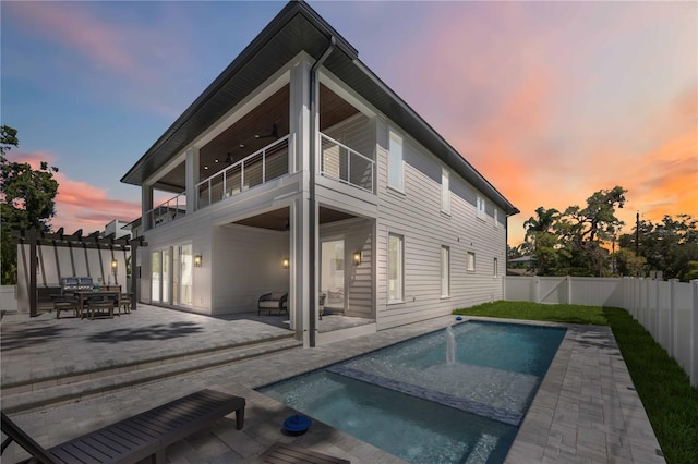 2596 Floyd St, Sarasota, FL 34239 - back of property with a balcony, a fenced backyard, a patio, an in-ground hot tub, and outdoor dining space