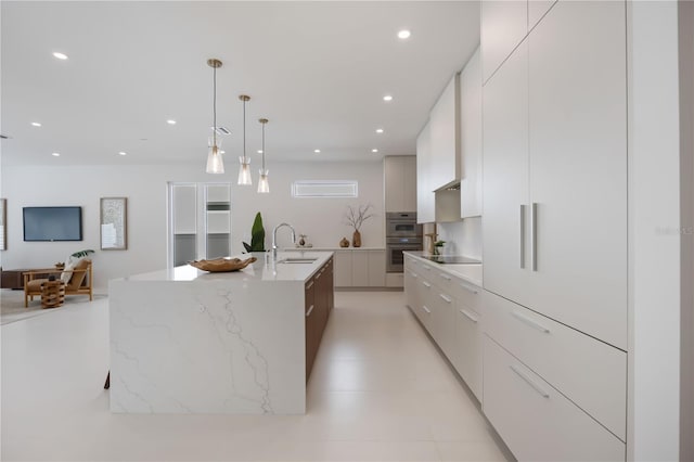 2596 Floyd St, Sarasota, FL 34239 - kitchen with modern cabinets, recessed lighting, an island with sink, white cabinets, and a sink