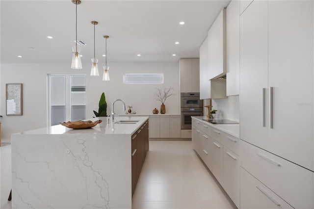 2596 Floyd St, Sarasota, FL 34239 - kitchen featuring modern cabinets, a sink, black electric cooktop, recessed lighting, and a center island with sink