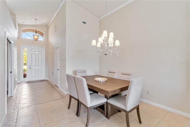 6519 43rd Ct E, Sarasota, FL 34243 - dining area with an inviting chandelier, high vaulted ceiling, visible vents, baseboards, and light tile patterned flooring