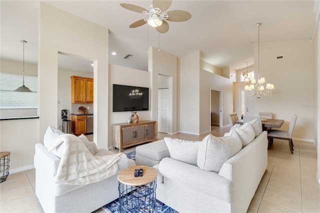 6519 43rd Ct E, Sarasota, FL 34243 - living room featuring light tile patterned floors, ceiling fan with notable chandelier, high vaulted ceiling, visible vents, and baseboards