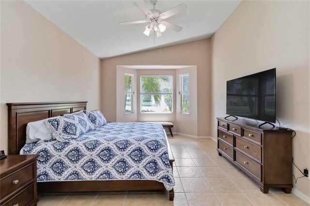 6519 43rd Ct E, Sarasota, FL 34243 - bedroom with light tile patterned floors, vaulted ceiling, baseboards, and a ceiling fan