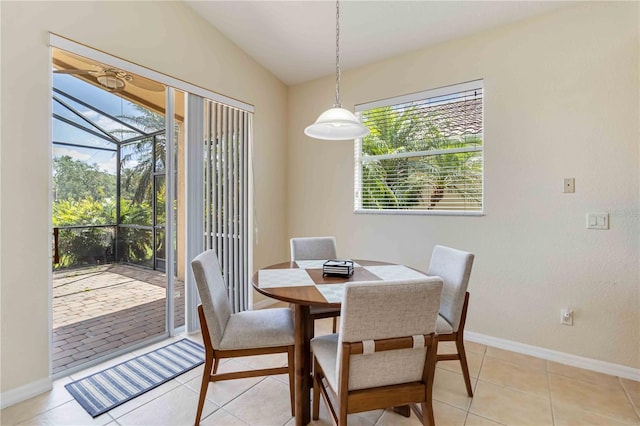 6519 43rd Ct E, Sarasota, FL 34243 - dining space with lofted ceiling, a ceiling fan, baseboards, light tile patterned floors, and a sunroom