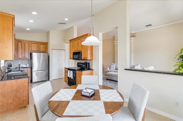 6519 43rd Ct E, Sarasota, FL 34243 - dining area with light tile patterned floors, visible vents, baseboards, vaulted ceiling, and recessed lighting