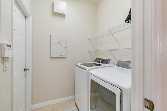 6519 43rd Ct E, Sarasota, FL 34243 - laundry room with laundry area, light tile patterned flooring, baseboards, and independent washer and dryer