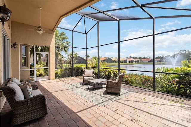 6519 43rd Ct E, Sarasota, FL 34243 - view of patio featuring a water view, a residential view, ceiling fan, and glass enclosure