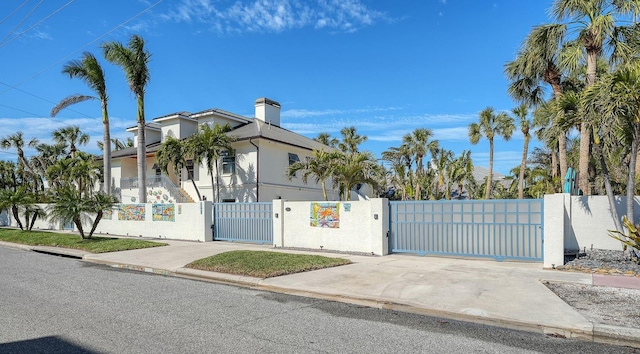 345 Madison Dr, Sarasota, FL 34236 - view of front of home with fence private yard, a gate, stucco siding, and a chimney