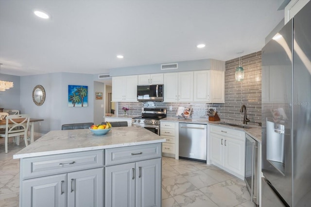 kitchen with visible vents, marble finish floor, white cabinets, a sink, and stainless steel appliances