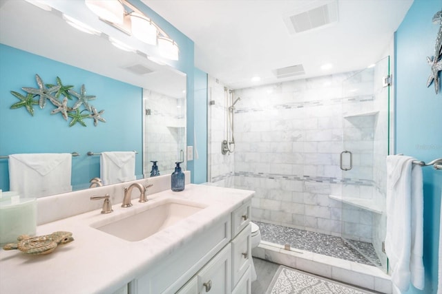 full bathroom with vanity, recessed lighting, a shower stall, wood finished floors, and visible vents