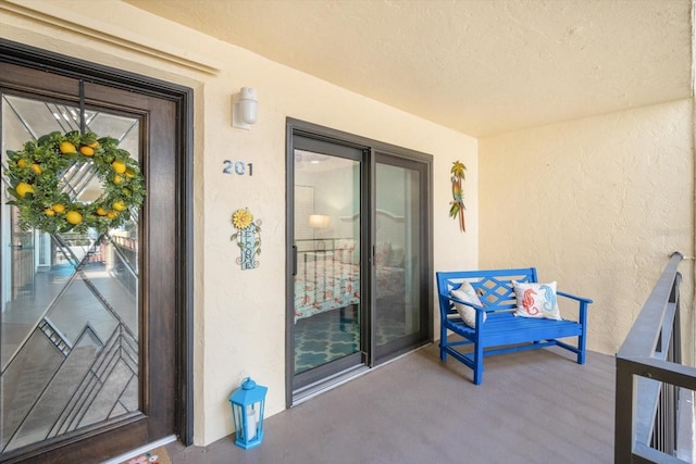view of exterior entry featuring stucco siding