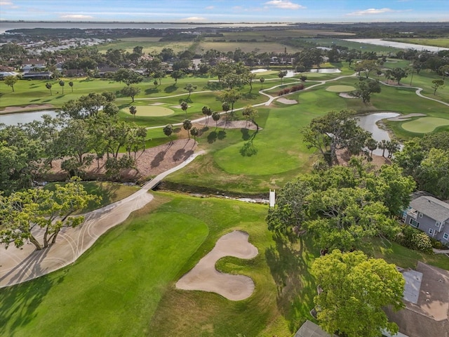 drone / aerial view with a water view, view of golf course, and a residential view