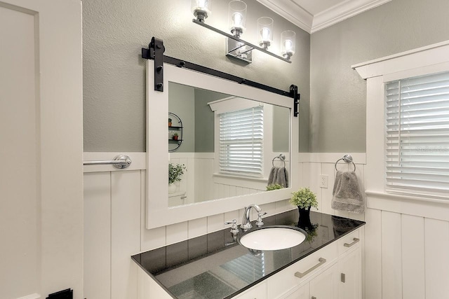 1814 6th Ave W, Bradenton, FL 34205 - bathroom featuring crown molding, a decorative wall, wainscoting, and vanity