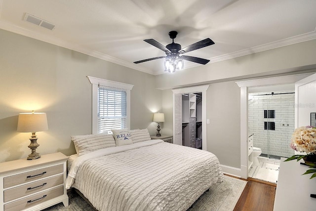 1814 6th Ave W, Bradenton, FL 34205 - bedroom with visible vents, ornamental molding, a closet, dark wood-style floors, and connected bathroom