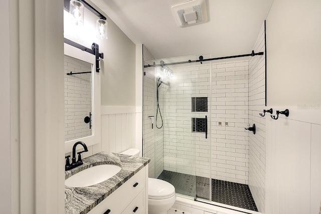 1814 6th Ave W, Bradenton, FL 34205 - full bathroom with vanity, toilet, a wainscoted wall, a shower stall, and visible vents