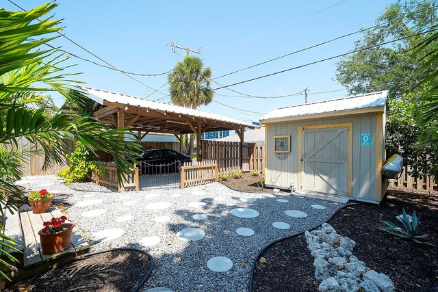 1814 6th Ave W, Bradenton, FL 34205 - view of patio featuring a fenced backyard, a storage unit, an outbuilding, and a gazebo