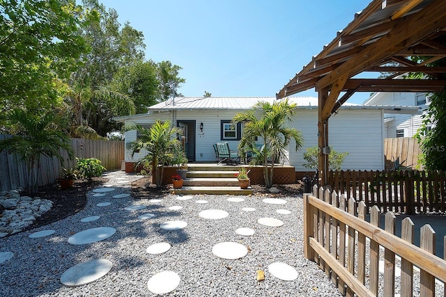 1814 6th Ave W, Bradenton, FL 34205 - rear view of house featuring fence and metal roof