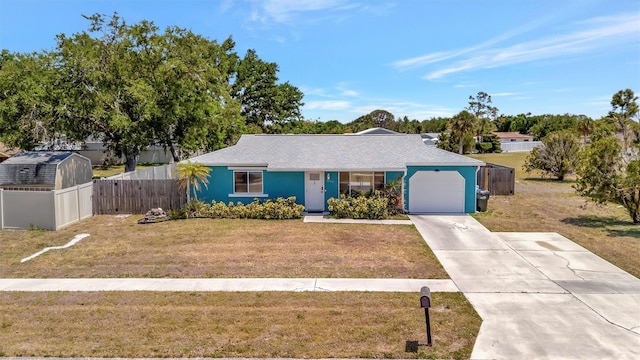 single story home with a front yard, driveway, a garage, and fence