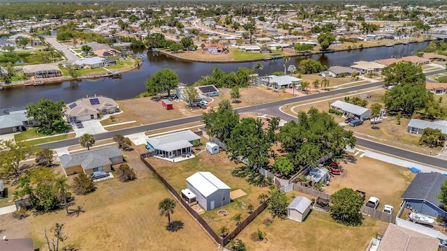birds eye view of property with a residential view and a water view