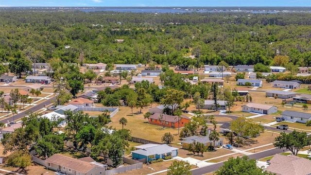 aerial view featuring a wooded view and a residential view