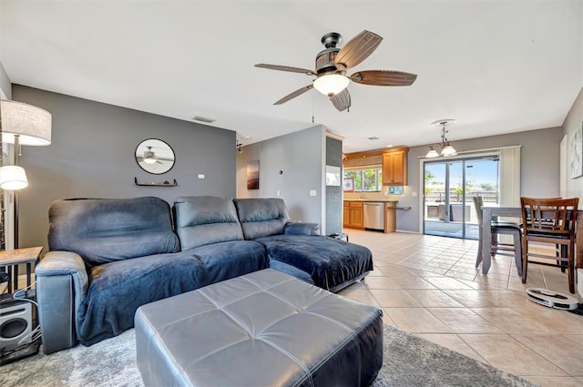 living area featuring light tile patterned floors, a ceiling fan, and visible vents