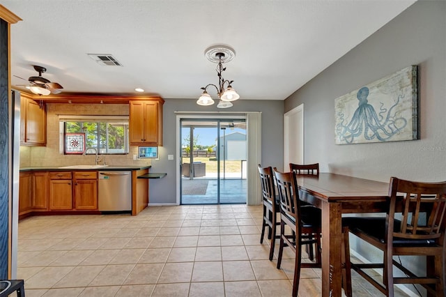dining space featuring light tile patterned flooring, visible vents, and a ceiling fan