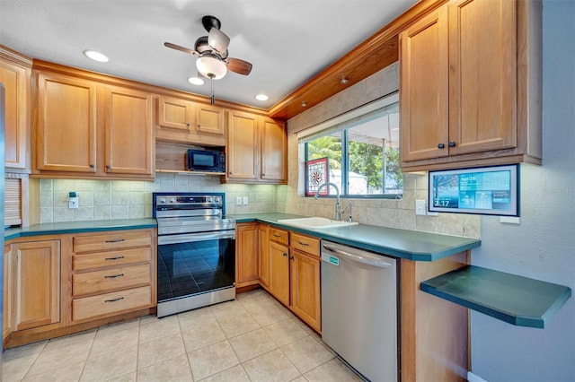 kitchen with tasteful backsplash, a sink, appliances with stainless steel finishes, light tile patterned flooring, and a ceiling fan