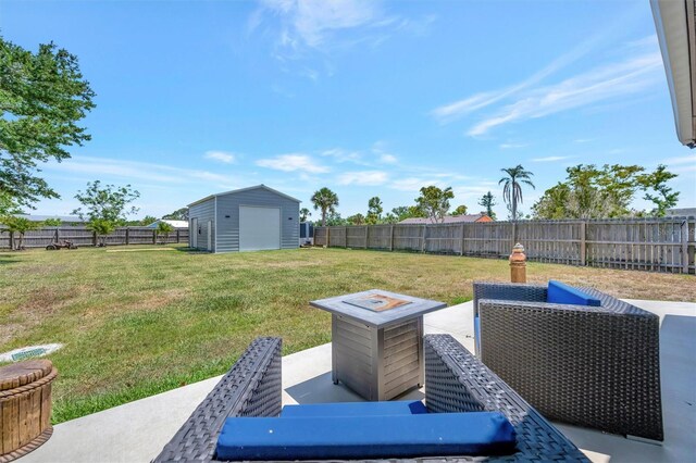 view of yard featuring an outdoor structure, a fenced backyard, a patio area, and a storage shed