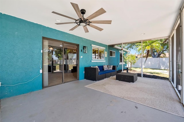 exterior space featuring fence, a ceiling fan, and an outdoor living space
