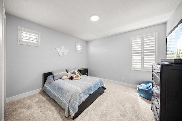 bedroom featuring carpet floors and baseboards
