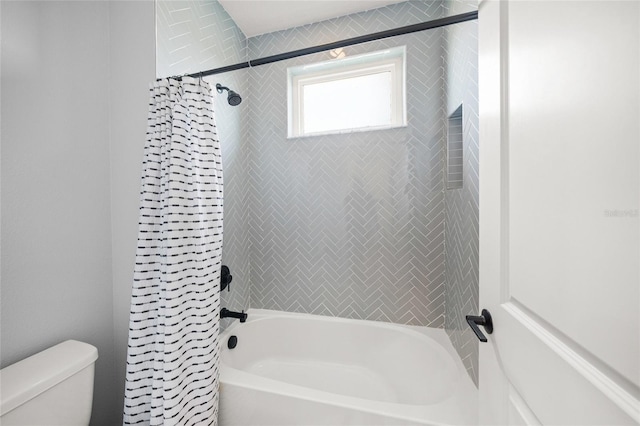 bathroom with toilet and shower / bathtub combination with curtain