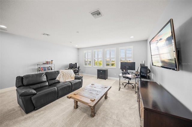 living room with baseboards, light carpet, recessed lighting, and visible vents