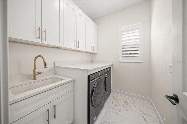 washroom with independent washer and dryer, cabinet space, a sink, marble finish floor, and baseboards