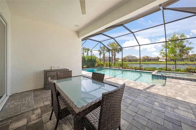 view of pool featuring a lanai, a patio area, and a pool with connected hot tub