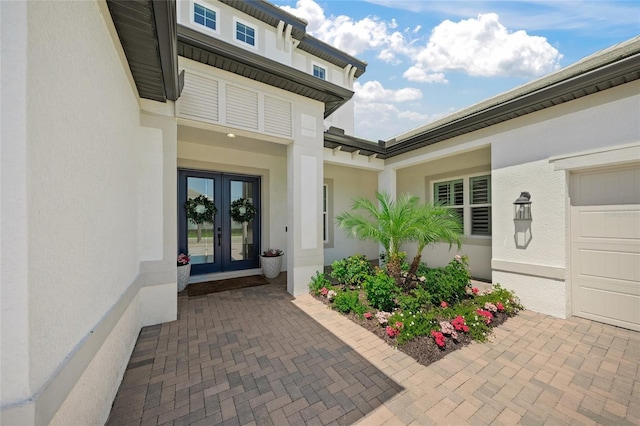 property entrance featuring stucco siding and french doors