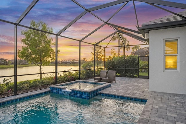 view of swimming pool with a patio, a water view, a pool with connected hot tub, and glass enclosure