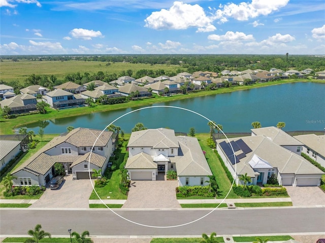 birds eye view of property featuring a water view and a residential view