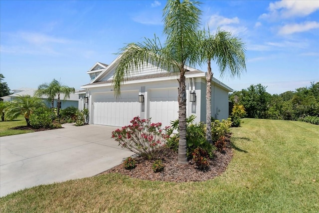 view of home's exterior featuring a yard, a garage, driveway, and stucco siding