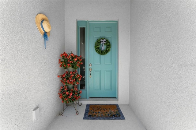 view of exterior entry featuring stucco siding