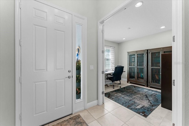foyer featuring recessed lighting, baseboards, and tile patterned flooring