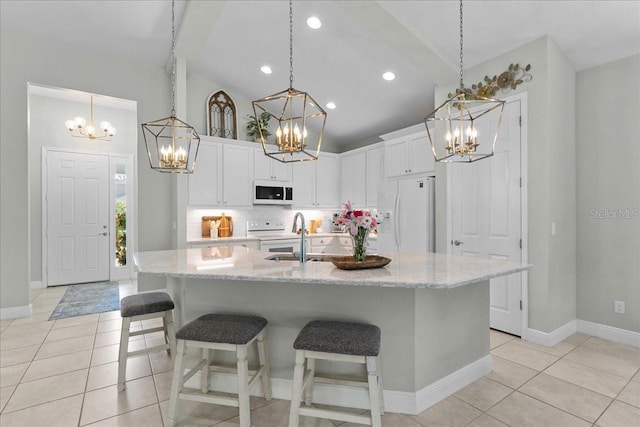 kitchen with baseboards, white cabinetry, a chandelier, and white appliances