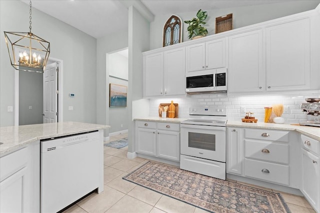 kitchen featuring white appliances, white cabinetry, an inviting chandelier, and tasteful backsplash