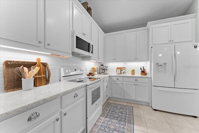 kitchen featuring decorative backsplash, white appliances, light stone countertops, white cabinetry, and light tile patterned floors