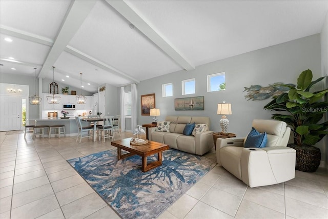 living room with light tile patterned floors, a chandelier, plenty of natural light, and vaulted ceiling with beams