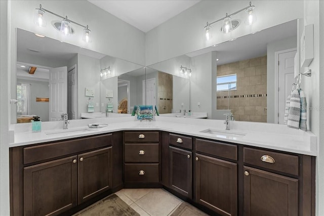 bathroom with tile patterned flooring, a sink, walk in shower, and double vanity