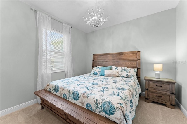 bedroom featuring light colored carpet, baseboards, and a chandelier