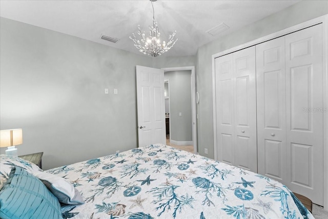 bedroom featuring a closet, a chandelier, and visible vents