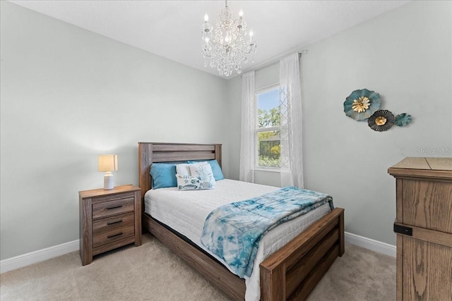 bedroom with light colored carpet, baseboards, and a notable chandelier