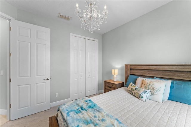 bedroom with visible vents, baseboards, a closet, a notable chandelier, and carpet